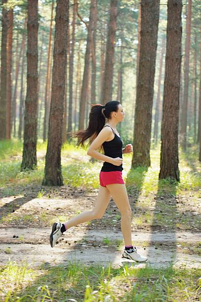 istock Woman jogging in forest 478029859