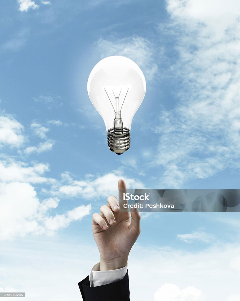 hand pointing at lamp hand pushing at lamp on a sky background Aiming Stock Photo