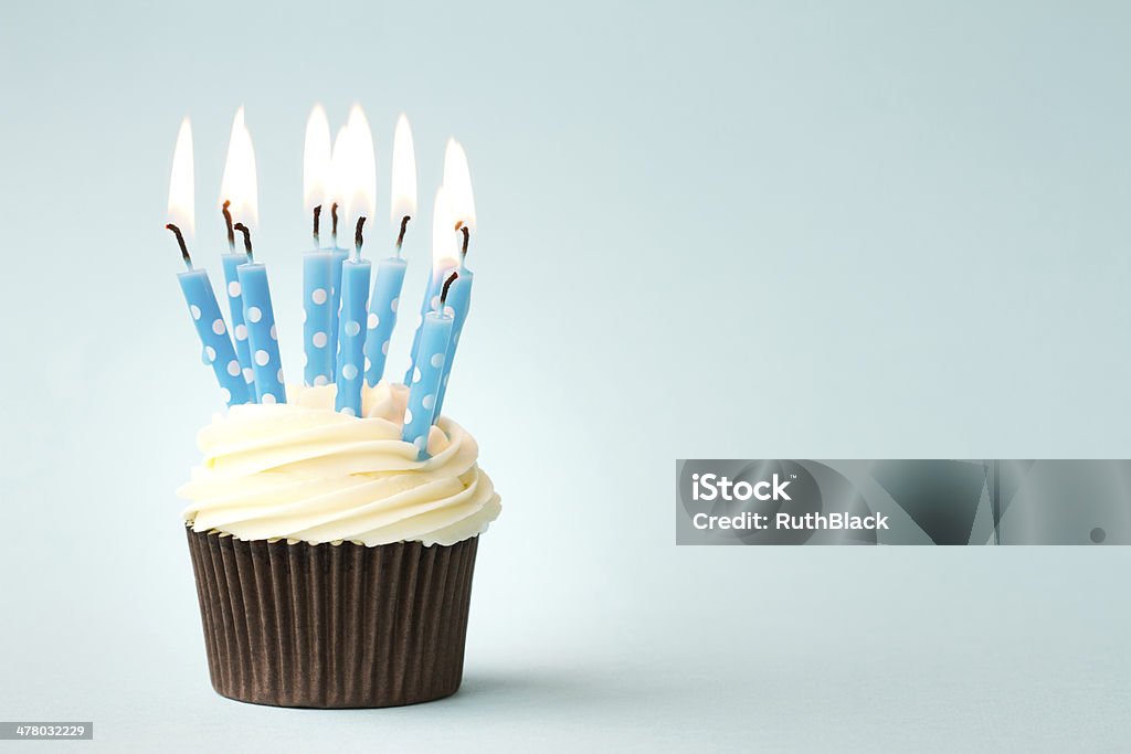 Birthday cupcake Cupcake decorated with birthday candles Blue Stock Photo