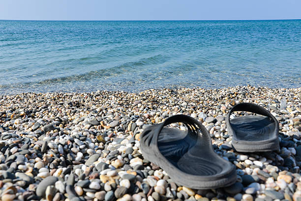 Flip-flops in front of the sea stock photo