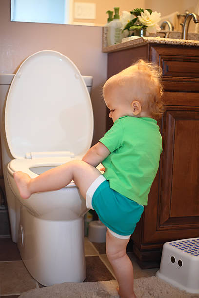 istock Baby trying to sit on a toilet 478032784
