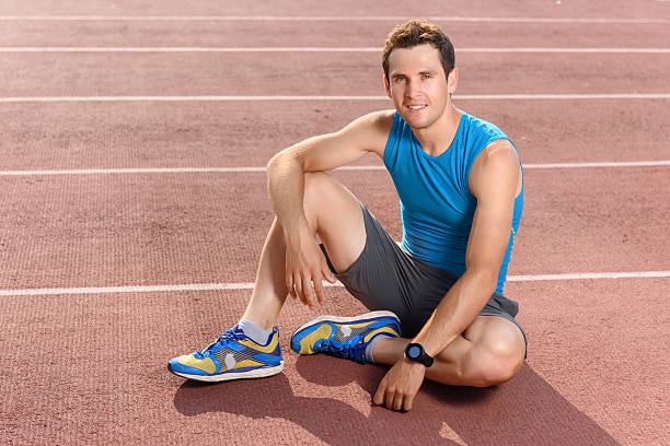 istock Smiling sportsman sitting and having rest 478032910