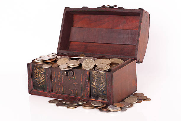 istock Wooden chest with coins inside isolated 478033259