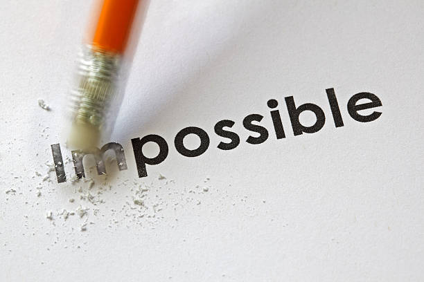From impossible to the possible Changing the word impossible to possible with a pencil eraser impossible possible stock pictures, royalty-free photos & images