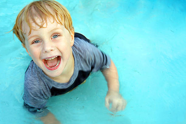 Happy Child Swimming in Pool