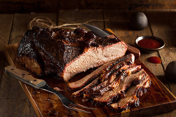 Homemade Smoked Barbecue Beef Brisket Homemade Smoked Barbecue Beef Brisket with Sauce brisket photos stock pictures, royalty-free photos & images