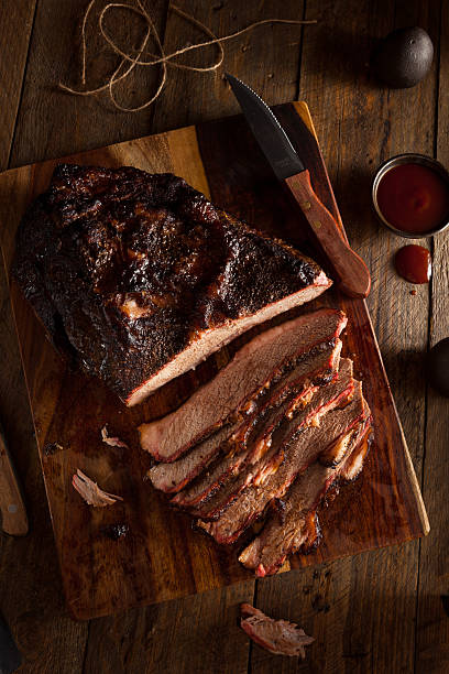 Homemade Smoked Barbecue Beef Brisket Homemade Smoked Barbecue Beef Brisket with Sauce brisket photos stock pictures, royalty-free photos & images