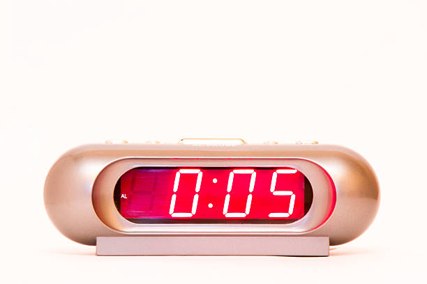 istock electronic clock alarm clock with red illumination and the time 0:05 478038232