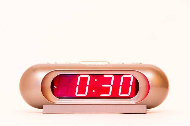 istock electronic clock alarm clock with red illumination and the time 0:30 478038264