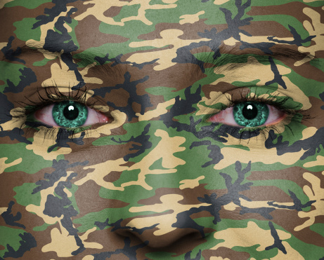 Woodland camouflage painted on woman a face - army concept
