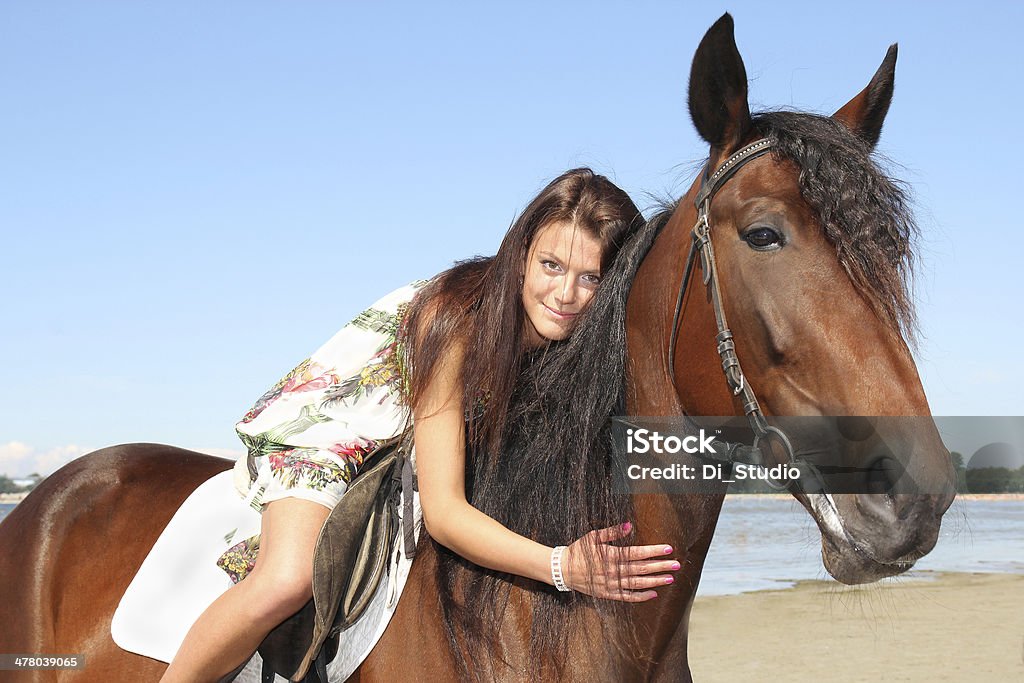 girl riding a horse girl riding a horse on the background of the sea Beach Stock Photo