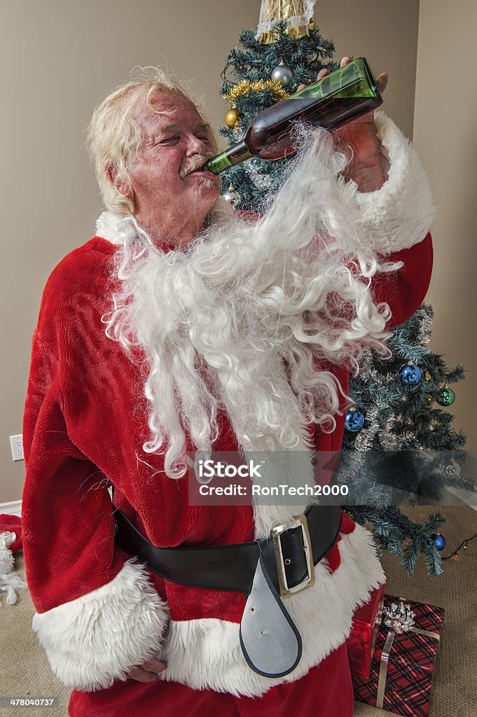 Crazy Old St Nick drink of wine in hand / ridiculous santa claus / with a goofy face Santa Claus Stock Photo