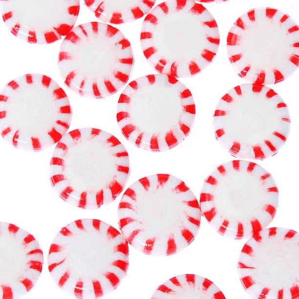 Peppermint candy isolated. Red and striped. Background. Peppermint candy isolated on white. Red striped peppermint Christmas candy, macro. Background. peppermints stock pictures, royalty-free photos & images