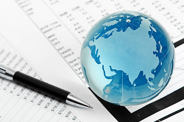 istock Glass globe and pen on finance 478041249