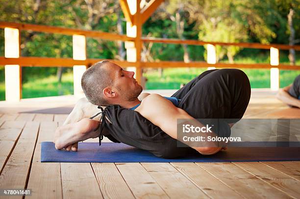 Yoga Trainer Show A Difficult Asana Stock Photo - Download Image Now - Active Lifestyle, Adult, Adults Only