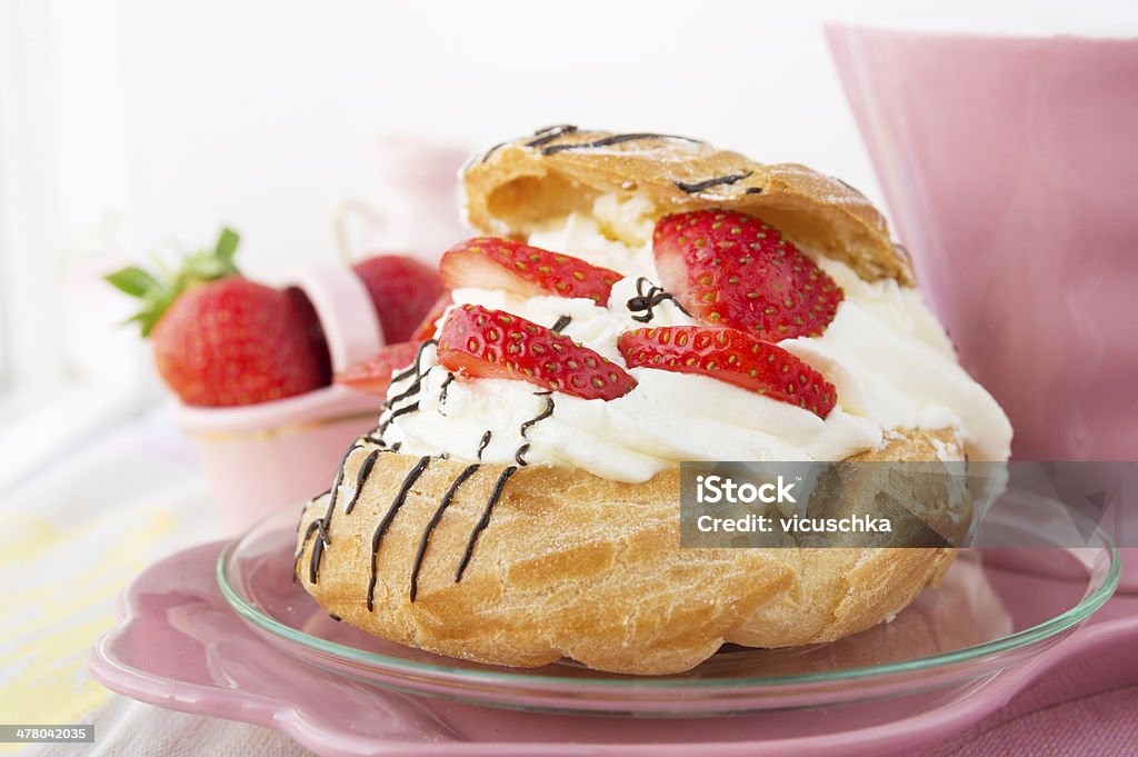 Cream Puffs with strawberries, pink service Baked Stock Photo