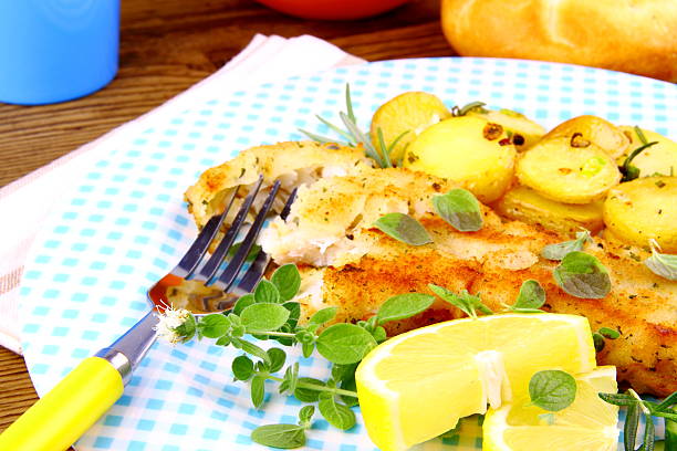 istock Rosemary potatoes and fish fillet fried with vegetables 478043451