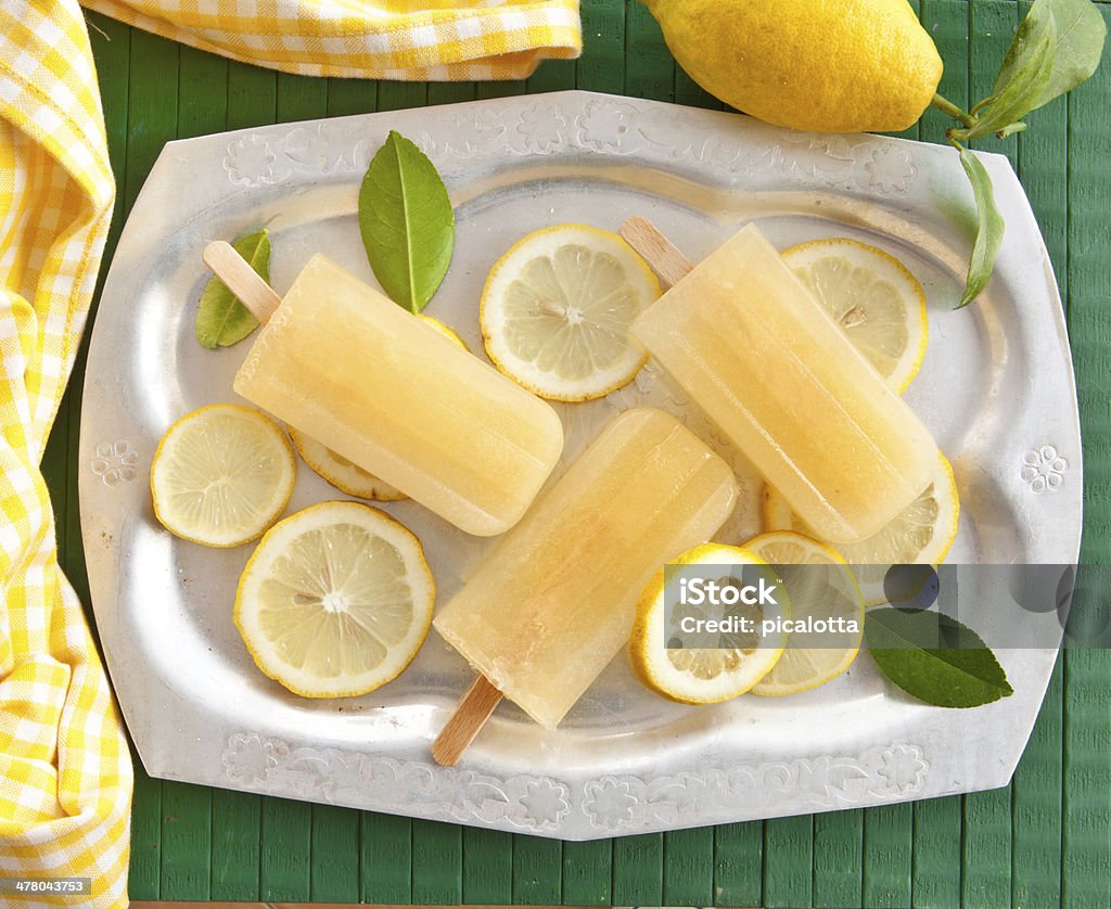 Fresh lemon popsicles Fresh lemon popsicles on slices of organic lemons Candy Stock Photo