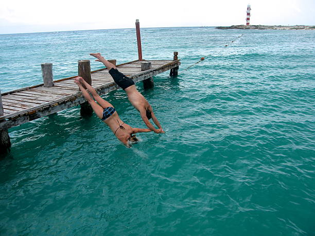 istock Couple Holding Hands While Diving into The Caribbean Sea 478044354