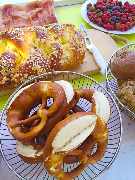 istock Brunch table with pretzels, fruits, ham, Hefezopf and buns 478044782