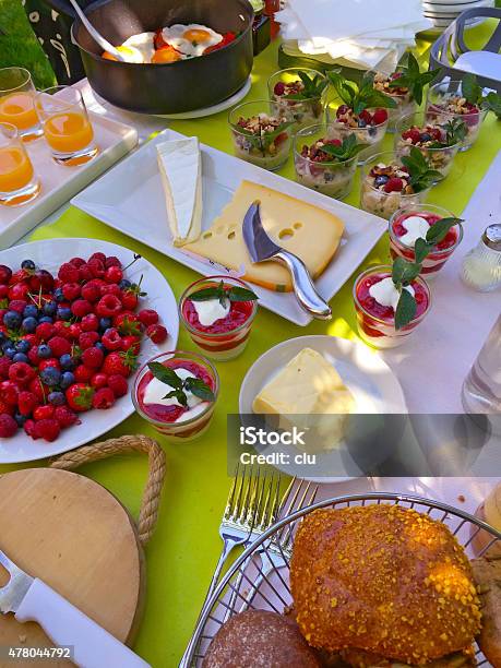Brunch Table With Buns Berries Butter Cheese Müsli Eggs Etc Stock Photo - Download Image Now