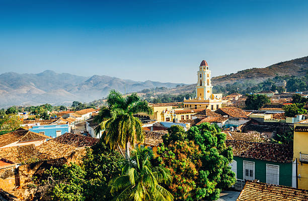 Trinidad, Cuba Panoramic view over the city of Trinidad, Cuba with mountains in the background and a blue sky. The bell tower belongs to the Iglesia y Convento de San Francisco. cuba stock pictures, royalty-free photos & images