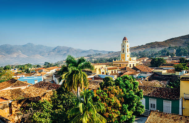 Trinidad, Cuba Panoramic view over the city of Trinidad, Cuba with mountains in the background and a blue sky. The bell tower belongs to the Iglesia y Convento de San Francisco. trinidad culture stock pictures, royalty-free photos & images