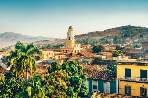 Panoramic view over the city of Trinidad, Cuba with mountains in the background and a cloudy sky