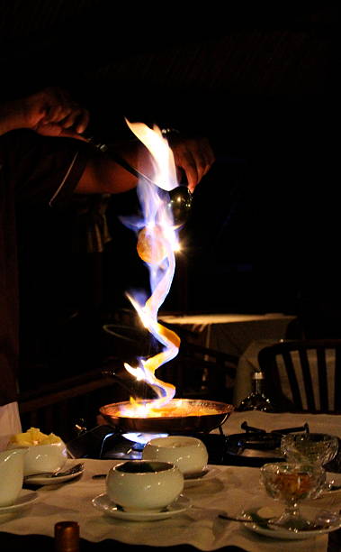Orange Peel Lit on Fire in Fijian Restaurant stock photo