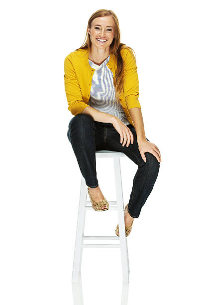 istock Young woman sitting on a stool 478048377