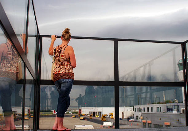 istock Young woman watching the airfield 478049575
