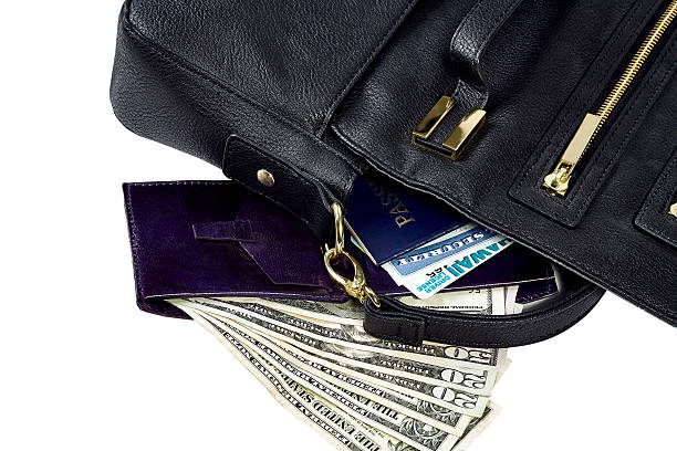 Women's Purse with Wallet and Identification Contents of purse spilled revealing passport, social security card, drivers license, wallet, US currency isolated on white social security social security card identity us currency stock pictures, royalty-free photos & images