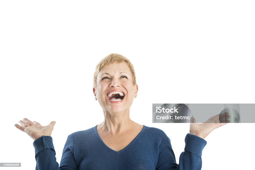 Cheerful Woman With Hands Raised Looking Up Cheerful mature woman with hands raised looking up against white background Mature Women Stock Photo