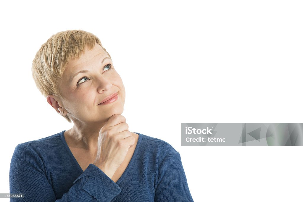 Thoughtful Woman With Hand On Chin Looking Up Thoughtful mature woman with hand on chin looking up against white background Women Stock Photo