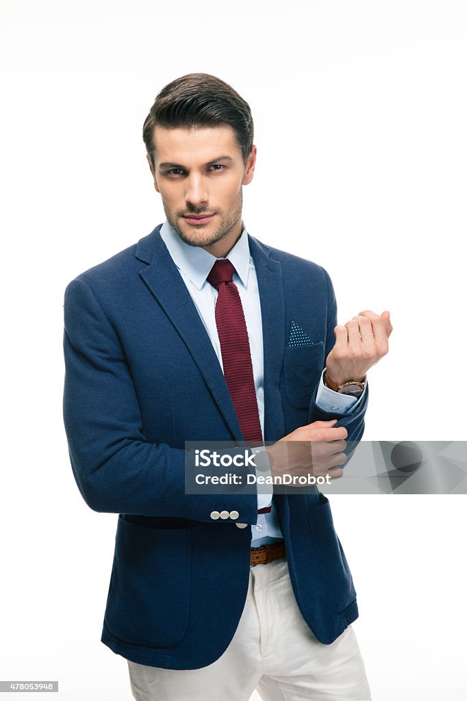 Happy handsome businessman buttoning jacket Happy handsome businessman buttoning jacket isolated on a white background. Looking at camera 2015 Stock Photo