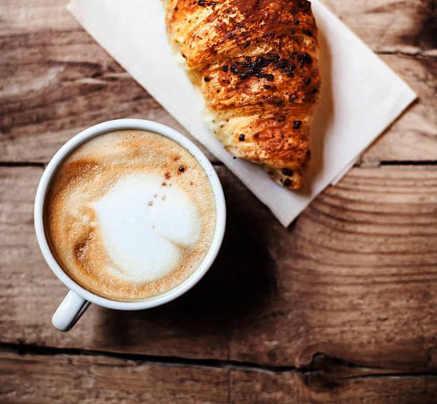 istock Coffee and fresh croissant for breakfast on rustic wooden table, 478055308