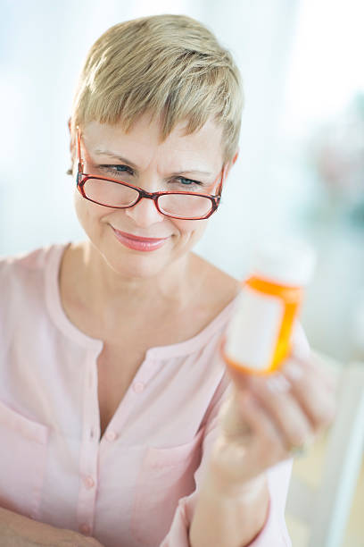 istock Woman Reading Instructions On Pill Bottle 478058837