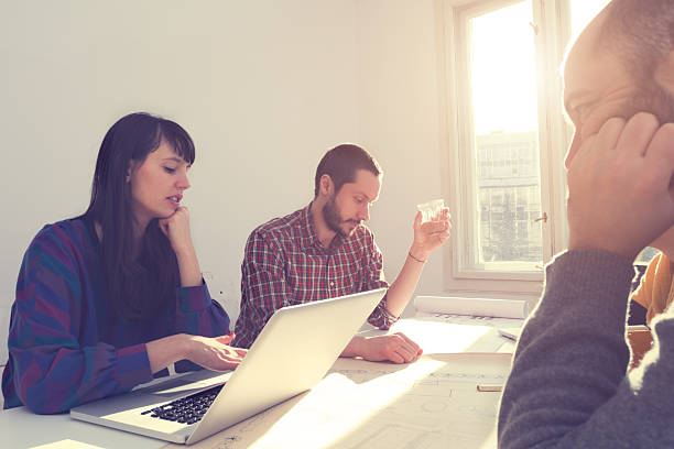 istock Young group of people/architects discussing business plans 478059026