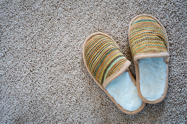 istock Slippers on the mat, top view with space for text 478059042