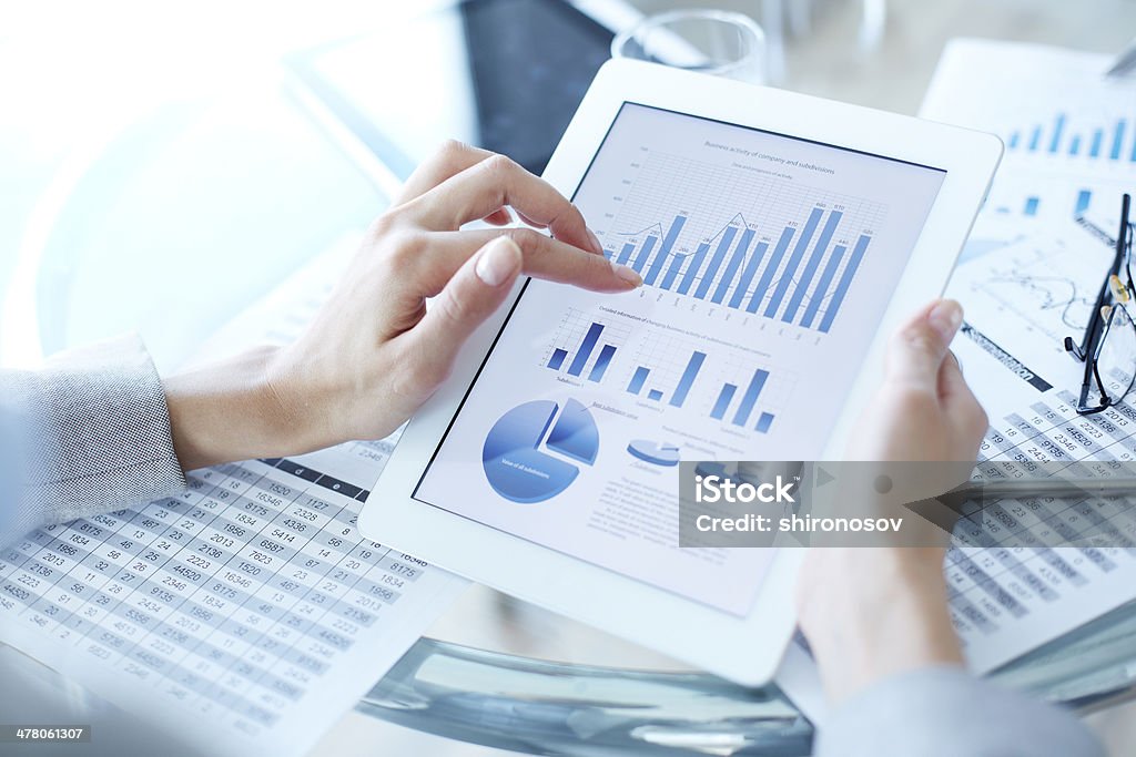 Touching lcd Above view of businesswoman hands holding touchpad screen Chart Stock Photo