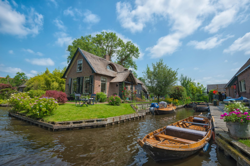 GIETHOORN, NETHERLANDS - JULY 3, 2013: view of typical houses of Giethoorn on July 3, 2013 in Giethoorn,The Netherlands. Giethoorn is also called 'the Venice of Holland' and receives 15.000 visitors yearly.