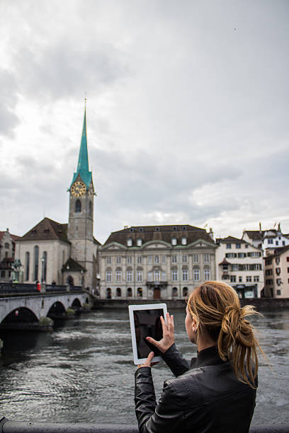 istock Young woman taking picture with digital tablet 478063629