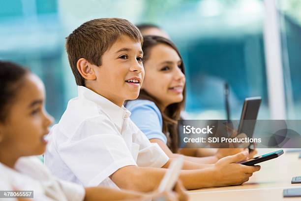 Private Elementary School Students Using Digital Tablet Technology In Class Stock Photo - Download Image Now
