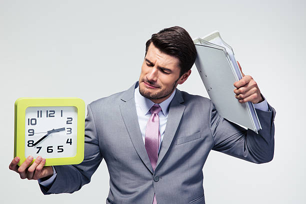 istock Disappointed businessman holding folders and clock 478067216