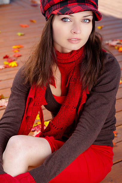 istock Young woman sitting on autumn leaves 478068167