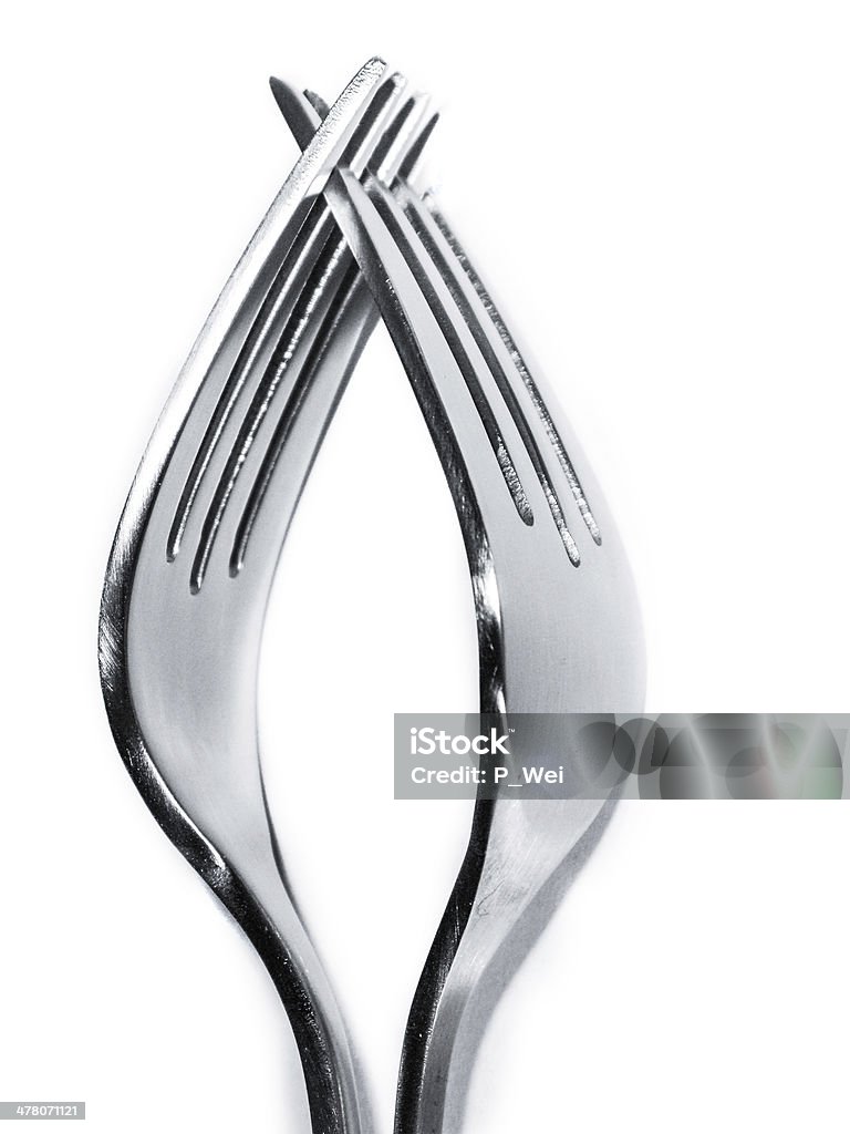 touching forks pair of forks with a hand like embrace Cut Out Stock Photo