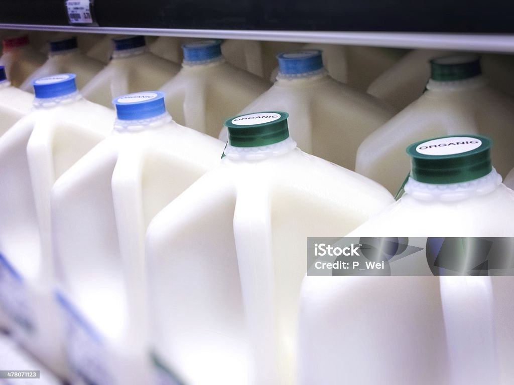 Gallon Jugs of Organic Milk at the Supermarket Bottles specifically labeled ORGANIC milk Milk Jug Stock Photo
