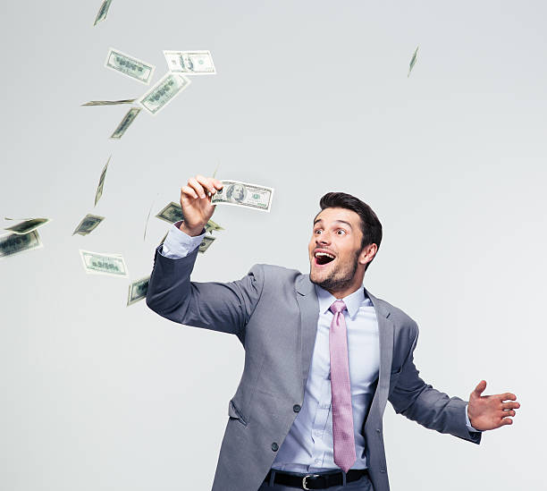 istock Businessman standing under money rain 478071194