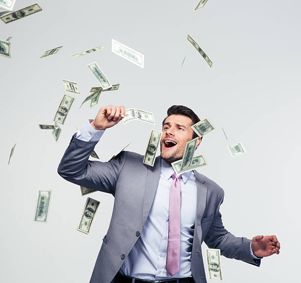 istock Businessman standing under money rain 478071226