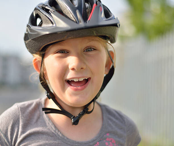 istock Young girl in a bicycle helmet. 478075135